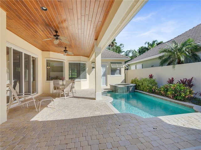 view of pool with a patio area, an in ground hot tub, and ceiling fan