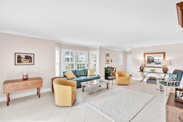 living room with ornamental molding and light tile patterned floors