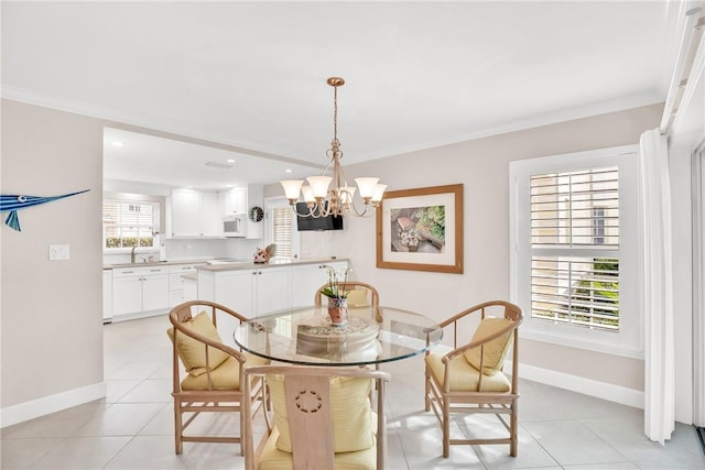 dining space featuring light tile patterned flooring, sink, a wealth of natural light, and a notable chandelier