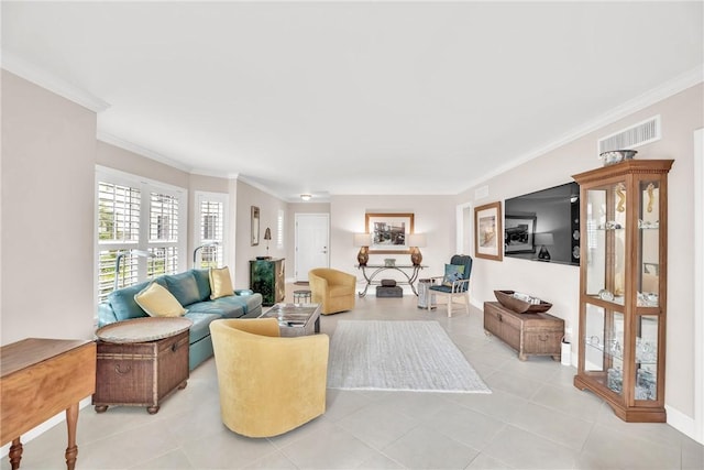 living room with ornamental molding and light tile patterned flooring