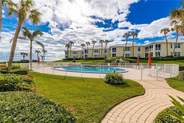 view of pool featuring a yard