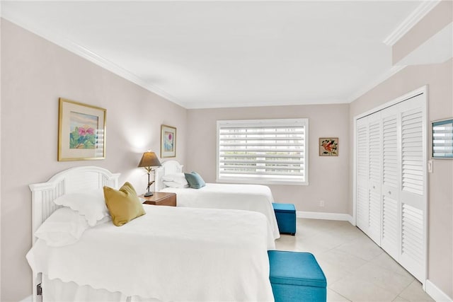 tiled bedroom with crown molding and a closet