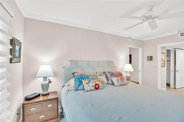 bedroom with ornamental molding and ceiling fan