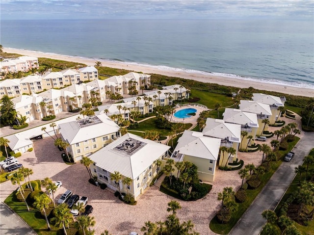 birds eye view of property with a view of the beach and a water view