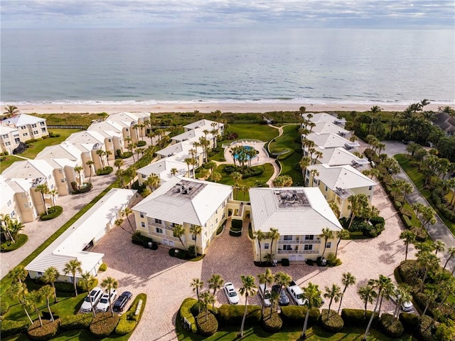 bird's eye view featuring a water view and a beach view