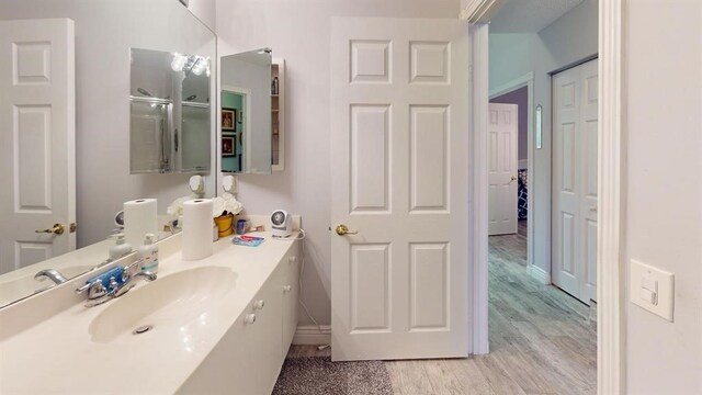 bathroom featuring vanity and hardwood / wood-style flooring