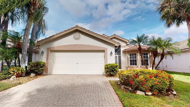 7549 Citronella St, Boynton Beach, FL 33437 - ranch-style home featuring stucco siding, an attached garage, decorative driveway, and a tile roof