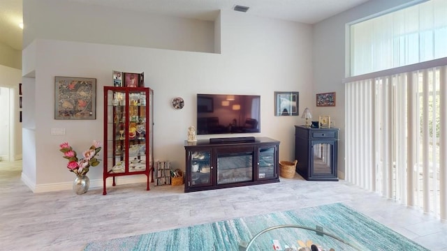 living room featuring a towering ceiling