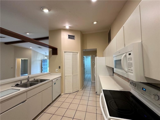 kitchen with sink, white cabinetry, lofted ceiling with beams, light tile patterned floors, and white appliances