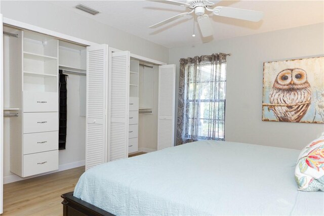 bathroom with hardwood / wood-style flooring, vanity, and an enclosed shower