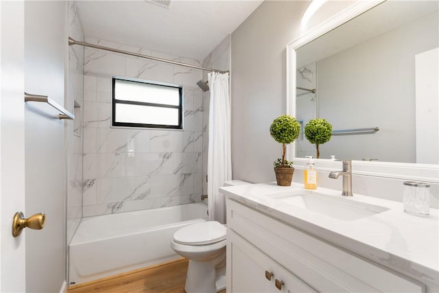 full bathroom with shower / bathtub combination with curtain, wood-type flooring, toilet, and vanity