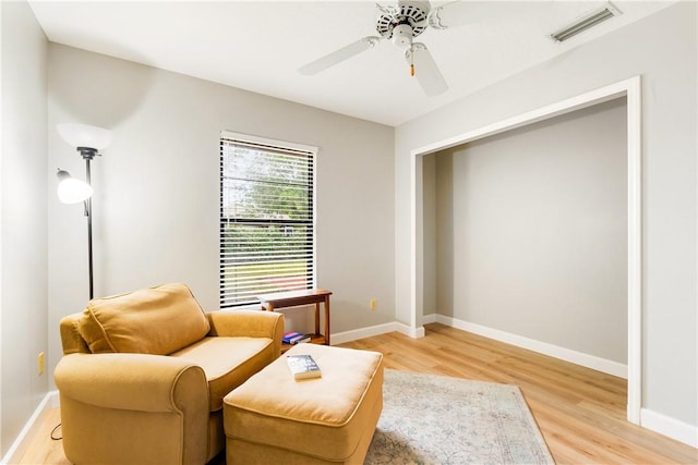 living area featuring ceiling fan and light wood-type flooring