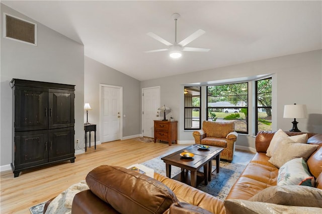 living room featuring light hardwood / wood-style flooring, ceiling fan, and vaulted ceiling