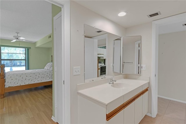 12 Plantation Dr Unit 205, Vero Beach, FL 32966 - ensuite bathroom with vanity, ceiling fan, and wood finished floors