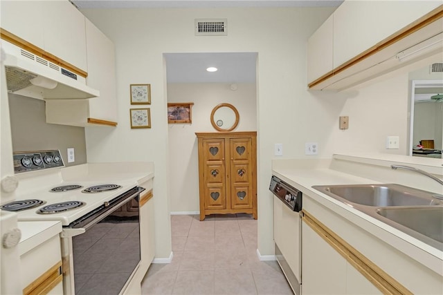 12 Plantation Dr Unit 205, Vero Beach, FL 32966 - kitchen featuring white appliances, under cabinet range hood, light tile patterned floors, light countertops, and white cabinetry