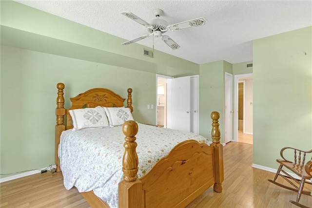 12 Plantation Dr Unit 205, Vero Beach, FL 32966 - bedroom with light wood-style floors, ceiling fan, and a textured ceiling