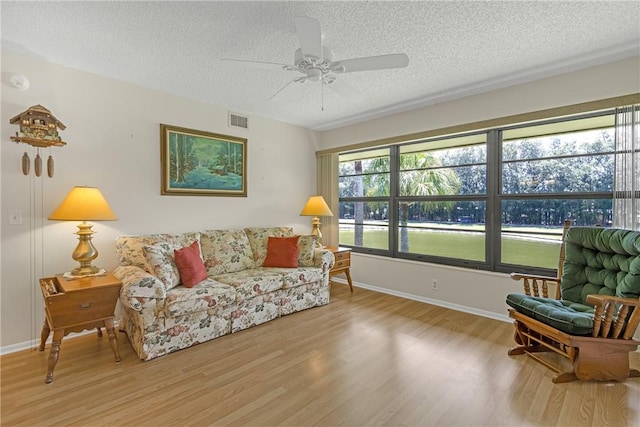 12 Plantation Dr Unit 205, Vero Beach, FL 32966 - living area featuring a textured ceiling, wood finished floors, and ceiling fan