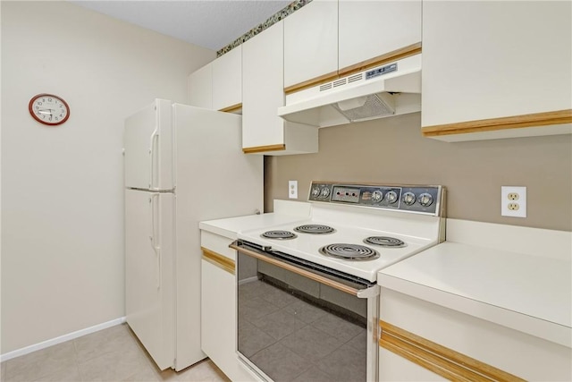 12 Plantation Dr Unit 205, Vero Beach, FL 32966 - kitchen featuring white appliances, under cabinet range hood, light countertops, white cabinets, and light tile patterned floors