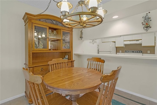 12 Plantation Dr Unit 205, Vero Beach, FL 32966 - dining room featuring a chandelier and light tile patterned flooring