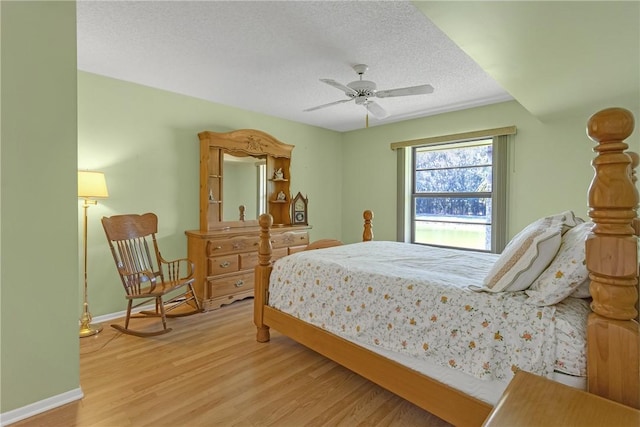 12 Plantation Dr Unit 205, Vero Beach, FL 32966 - bedroom featuring wood finished floors, a textured ceiling, and ceiling fan