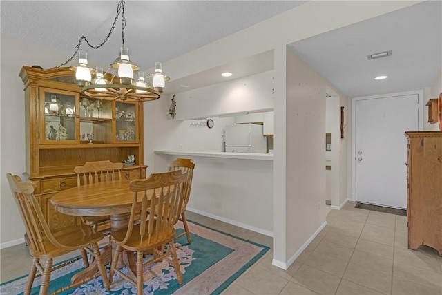12 Plantation Dr Unit 205, Vero Beach, FL 32966 - dining area with a chandelier, light tile patterned floors, and recessed lighting