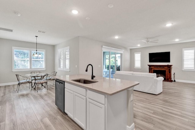 kitchen with ceiling fan, dishwasher, sink, pendant lighting, and white cabinets