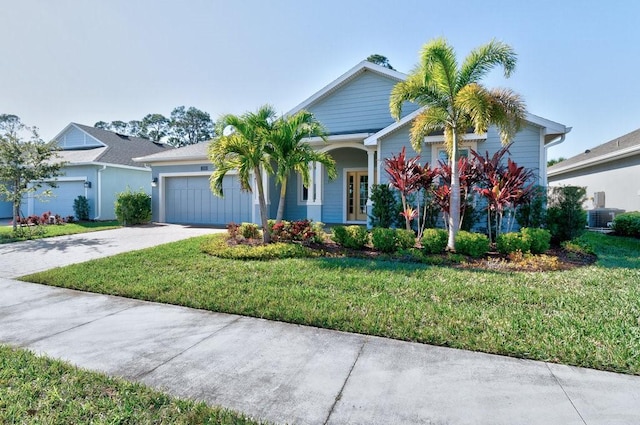 view of front facade featuring central AC unit, a garage, and a front lawn