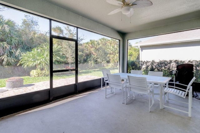 sunroom / solarium featuring ceiling fan