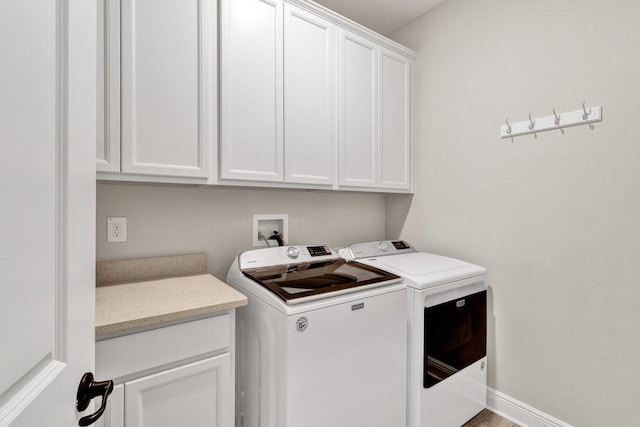 laundry area featuring cabinets and separate washer and dryer