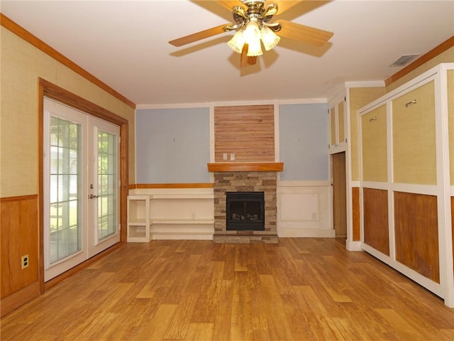 unfurnished living room with french doors, ornamental molding, visible vents, and light wood-style floors