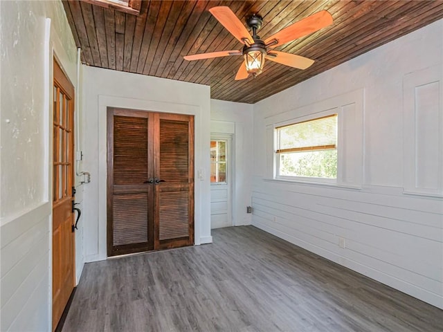 unfurnished room featuring wooden ceiling, dark wood-style floors, and a ceiling fan