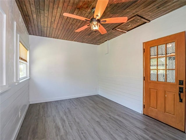 spare room featuring wooden ceiling, ceiling fan, and dark wood-style floors