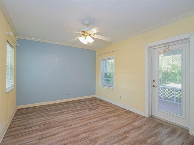 unfurnished room featuring ornamental molding, light wood-type flooring, and baseboards