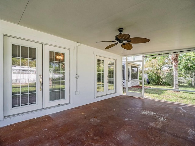 unfurnished sunroom featuring french doors and ceiling fan