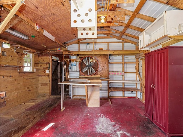 interior space with lofted ceiling and wooden walls