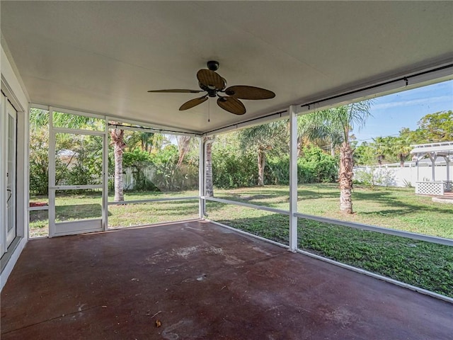 unfurnished sunroom featuring a ceiling fan