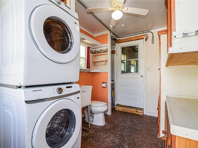 laundry area featuring laundry area, stacked washing maching and dryer, and a ceiling fan