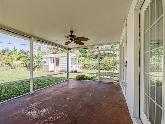 unfurnished sunroom featuring a ceiling fan