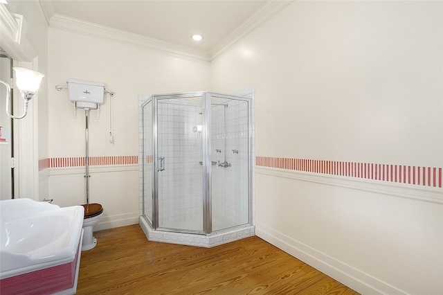 bathroom with toilet, an enclosed shower, hardwood / wood-style flooring, and crown molding