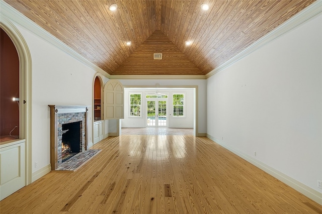 unfurnished living room featuring a stone fireplace, wood ceiling, vaulted ceiling, and light hardwood / wood-style floors