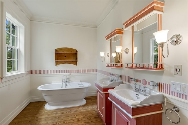 bathroom with hardwood / wood-style floors, a healthy amount of sunlight, and crown molding