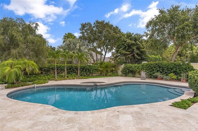 201 Sundial Ct, Vero Beach, FL 32963 - view of pool featuring an in-ground hot tub, a patio, and fence