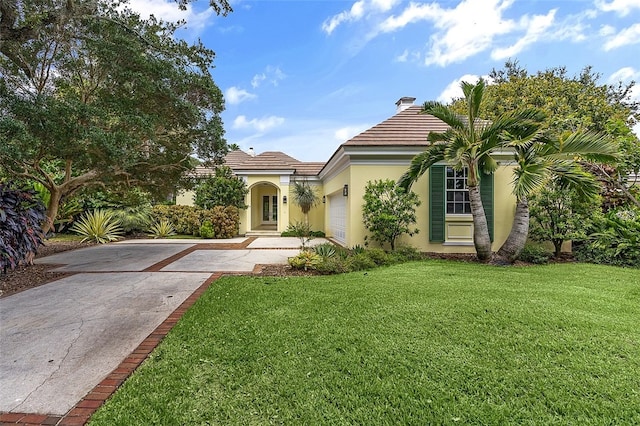 view of front of house with a front yard and a garage