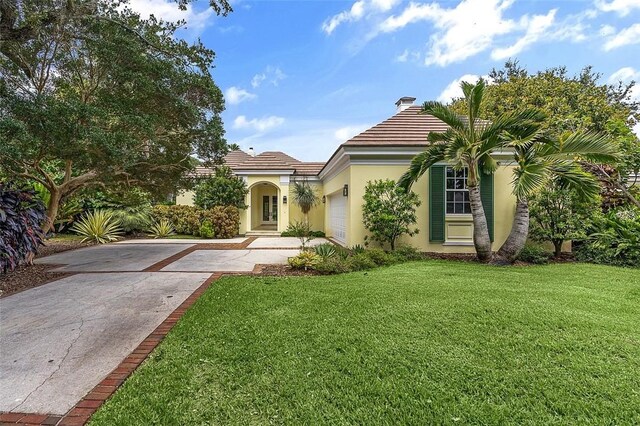 201 Sundial Ct, Vero Beach, FL 32963 - view of front of home featuring stucco siding, driveway, a garage, and a tile roof
