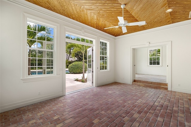 interior space featuring lofted ceiling, ceiling fan, crown molding, and wooden ceiling