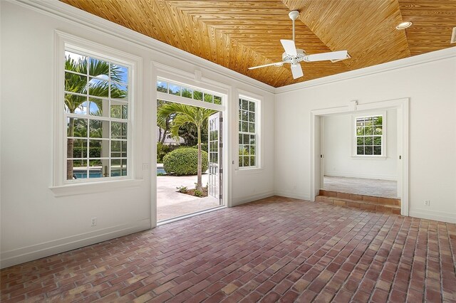 interior space featuring lofted ceiling, ceiling fan, crown molding, and wooden ceiling