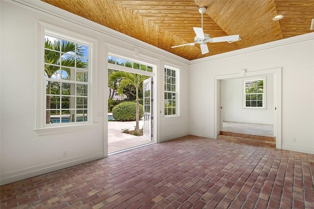 201 Sundial Ct, Vero Beach, FL 32963 - empty room with brick floors, baseboards, wooden ceiling, ceiling fan, and crown molding
