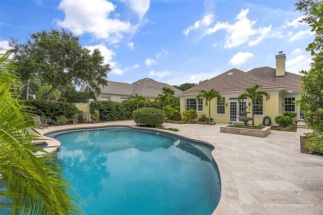 view of swimming pool with a patio area