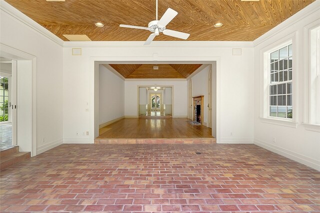 spare room with a wealth of natural light, wood ceiling, ceiling fan, and crown molding