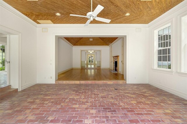 201 Sundial Ct, Vero Beach, FL 32963 - unfurnished room with wooden ceiling, baseboards, crown molding, ceiling fan, and brick patterned floors